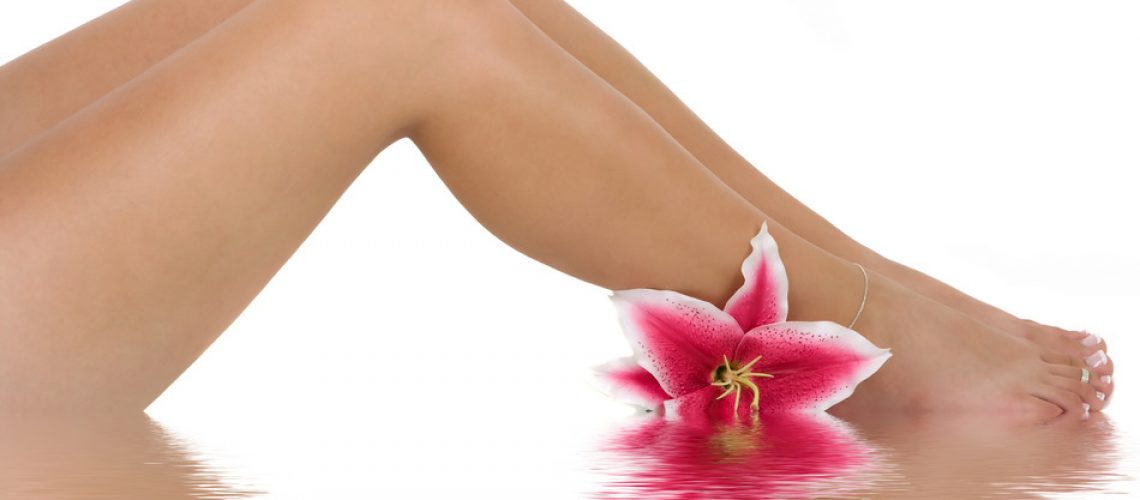 Beautiful legs with a pink lily flower